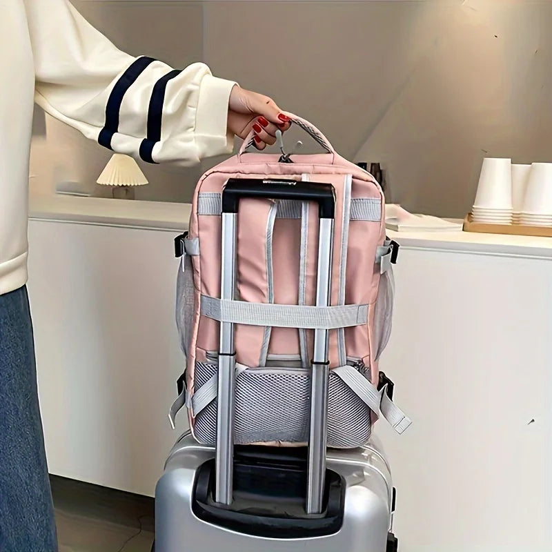 Pink travel backpack on suitcase, person holding handle, modern indoor setting, Elarose