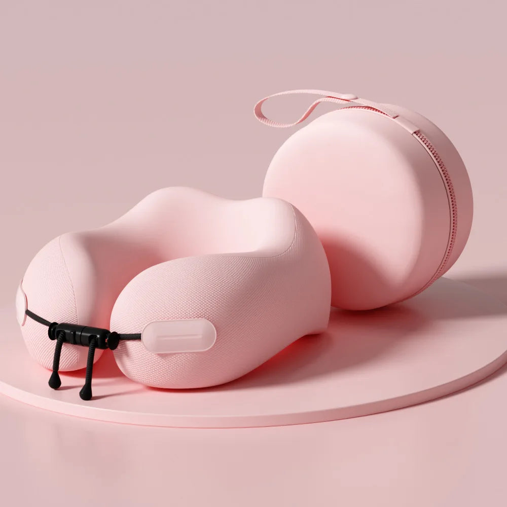 Pink memory foam travel neck pillow with matching zippered carrying case on soft pink background