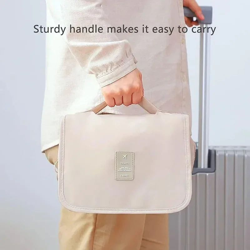 Person holding beige Elarose travel bag with sturdy handle next to suitcase