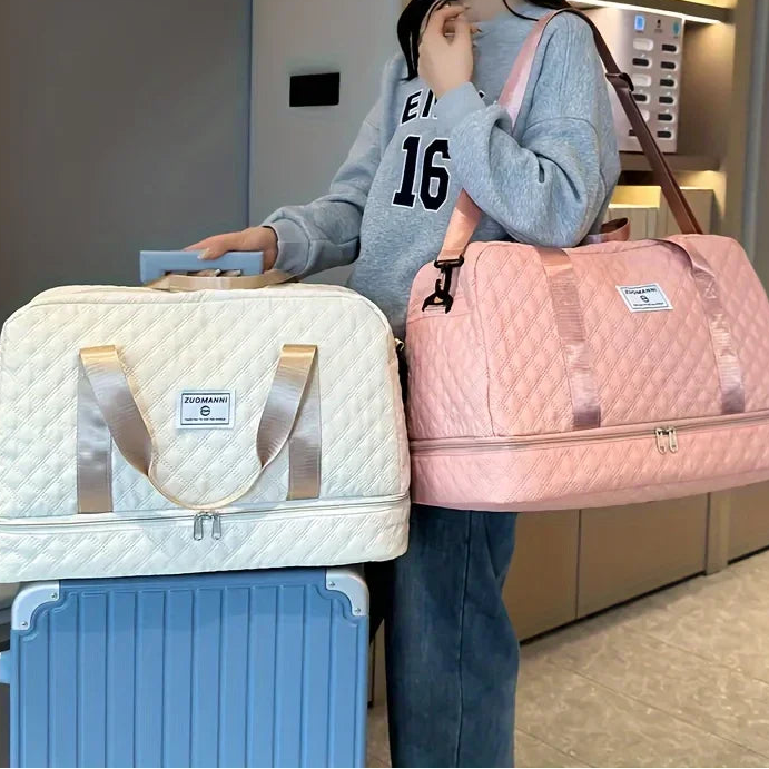 Woman with Elarose quilted duffel bags in cream and pink, standing by suitcase indoors