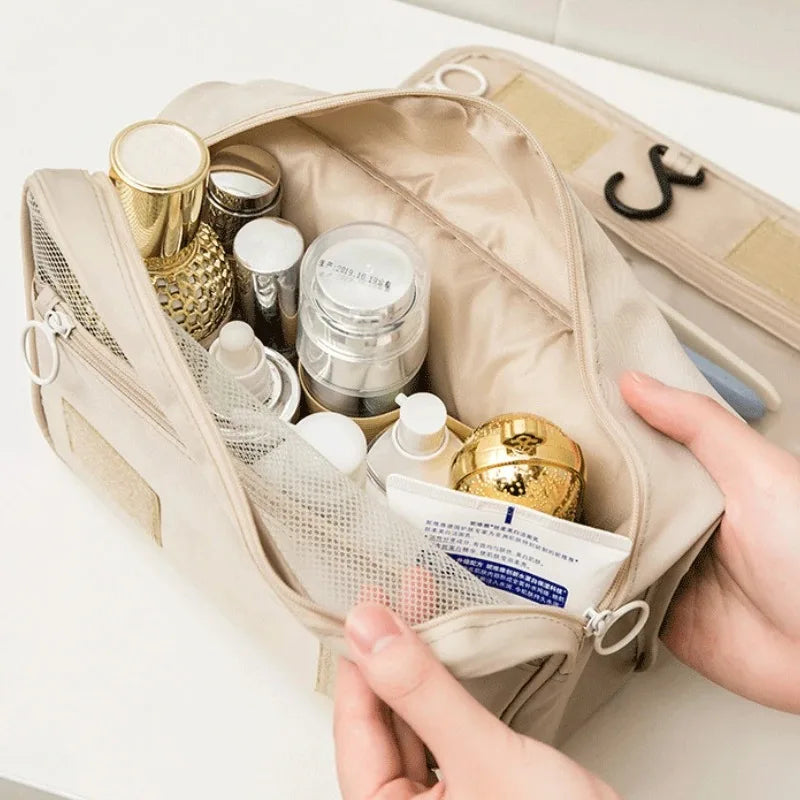 Beige Elarose travel cosmetic bag with skincare bottles and gold containers, organized neatly.