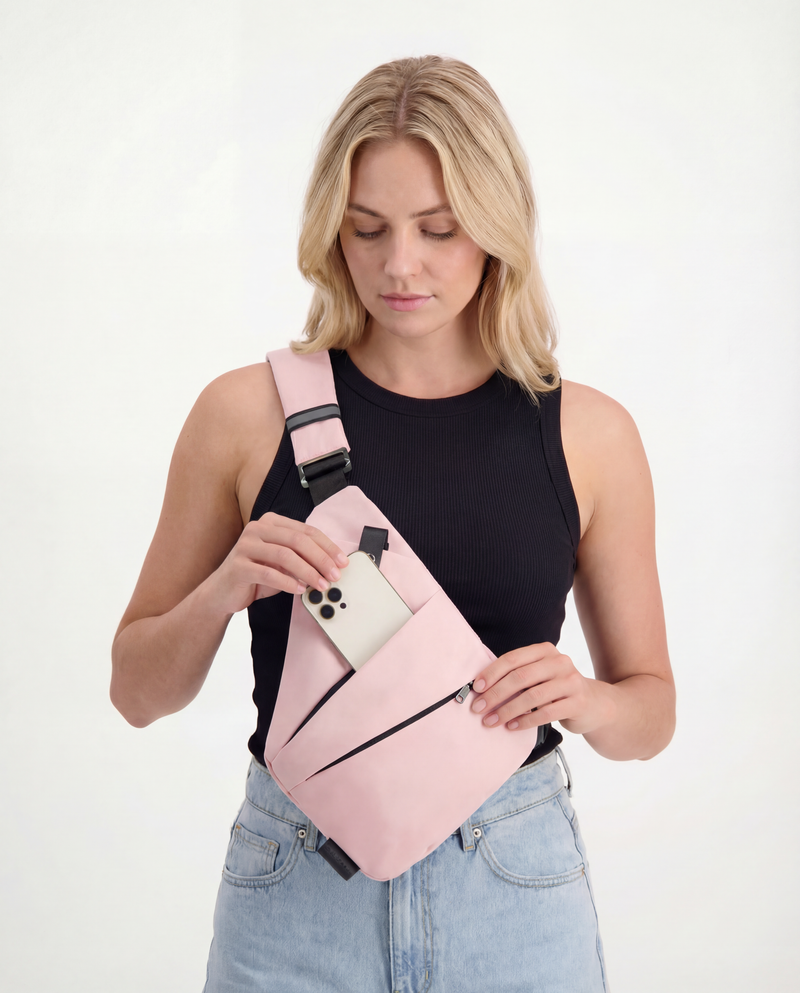 Pink backpack on suitcase, casual travel setup at counter, Elarose lifestyle accessory
