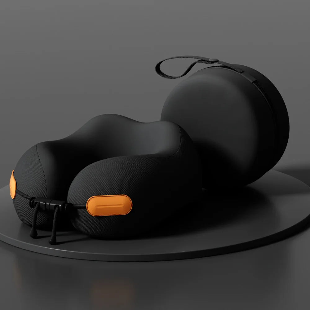 Black travel neck pillow with orange accents and matching carrying case on a dark surface