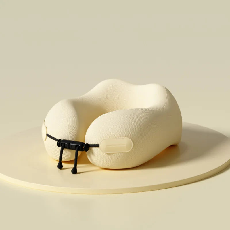 Elarose memory foam travel neck pillow in beige on a light round platform