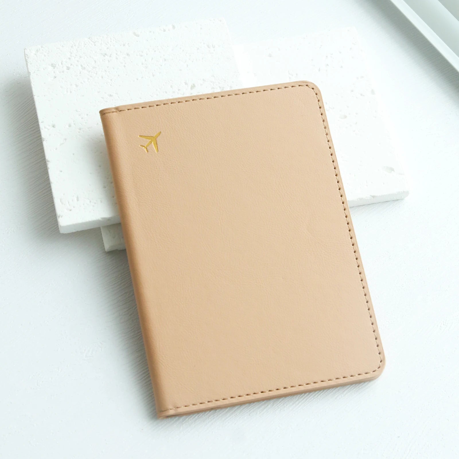 Beige leather travel passport holder with gold airplane icon, Elarose accessories