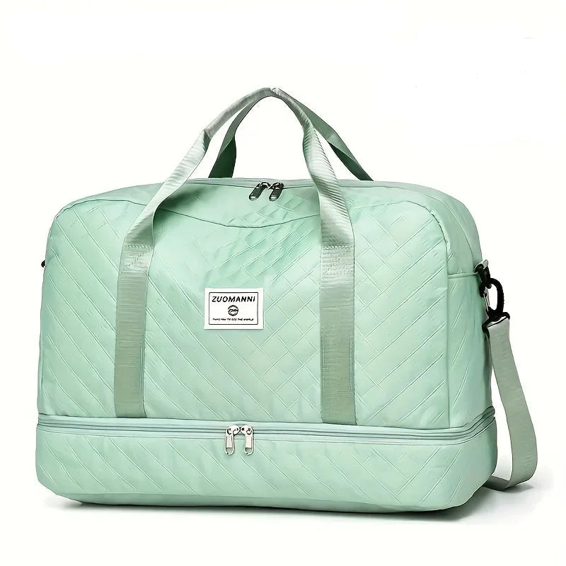Light green quilted travel duffel bag with handles, shoulder strap, and front logo patch