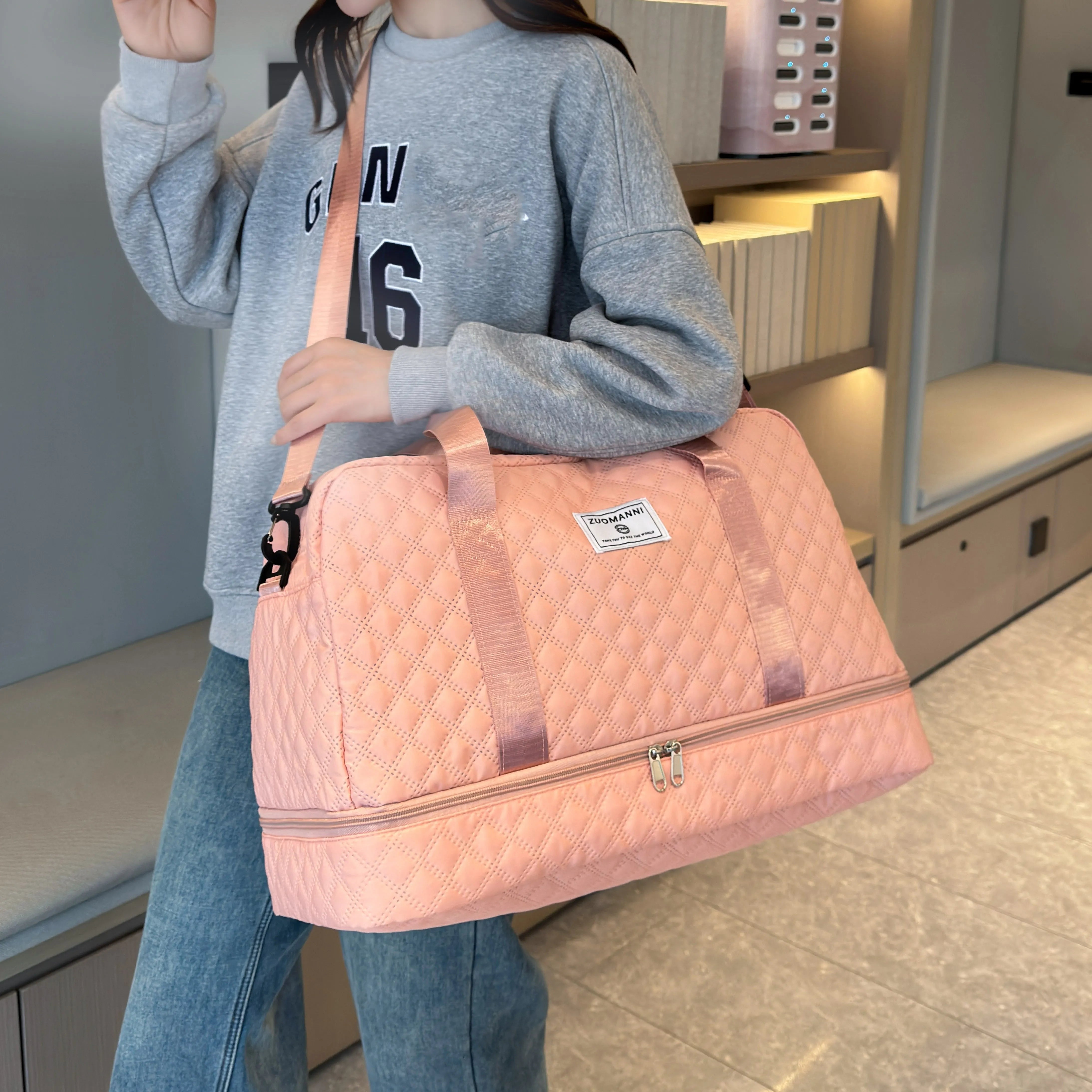 Woman holding pink quilted travel duffel bag with zipper, Elarose fashionable accessory
